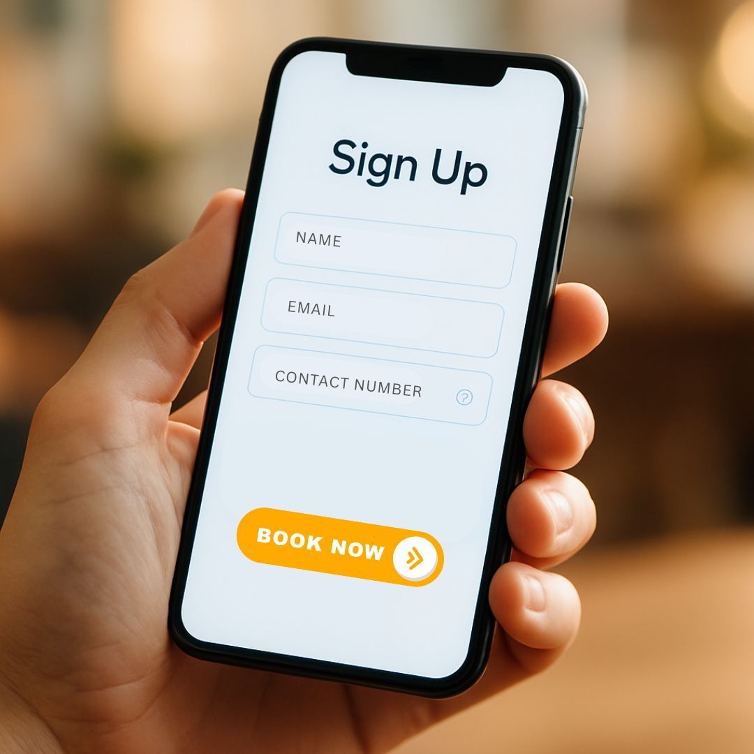 Hand holding a phone displaying a sign-up form with fields for name, email, and contact number; 