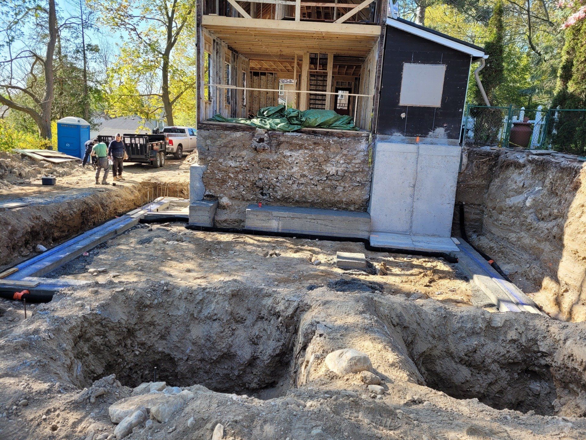 A house is being built in the middle of a dirt field.