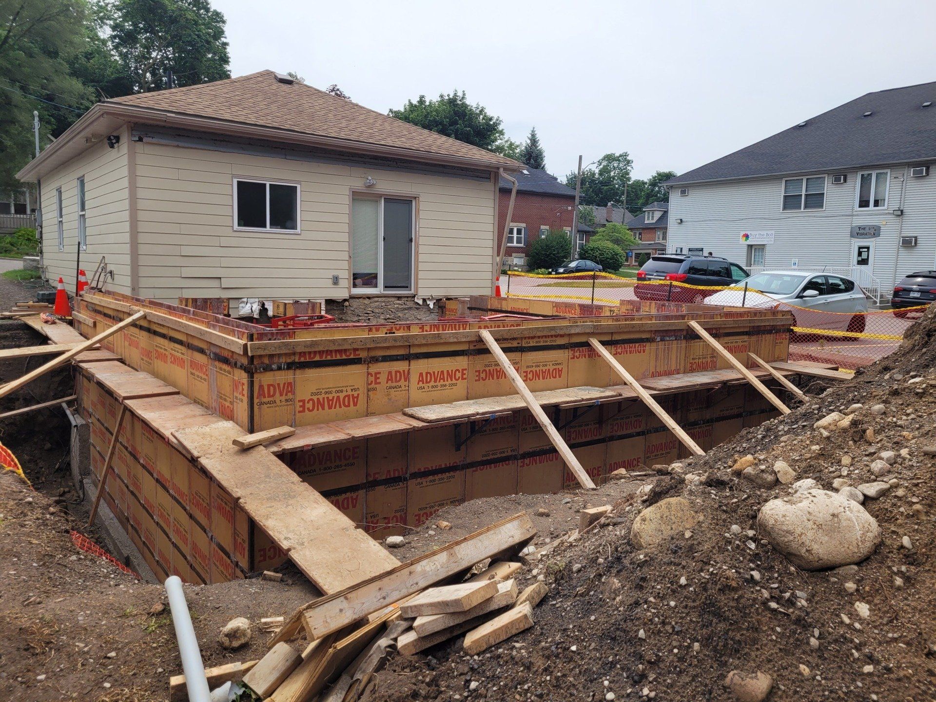 A house is being built in the middle of a dirt field.