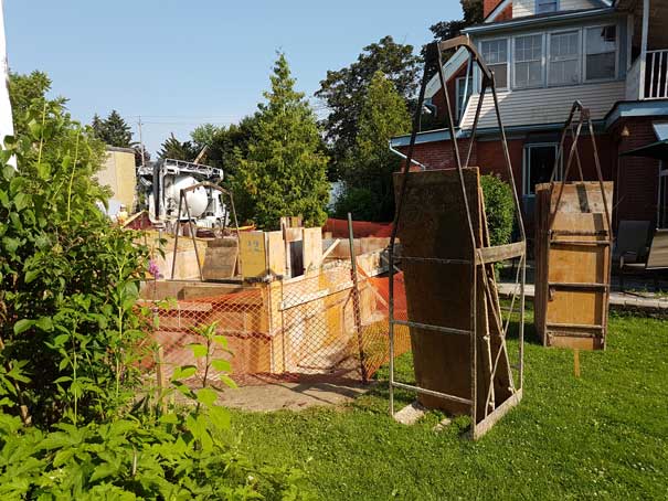 A construction site with a concrete mixer in the background.