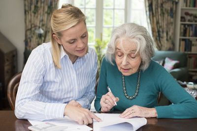 Woman and Her Mother Signing Paperwork — Morgan City, LA — Frank Judycki Attorney At Law Woman and Her Mother Signing Paperwork — Morgan City, LA — Frank Judycki Attorney At Law