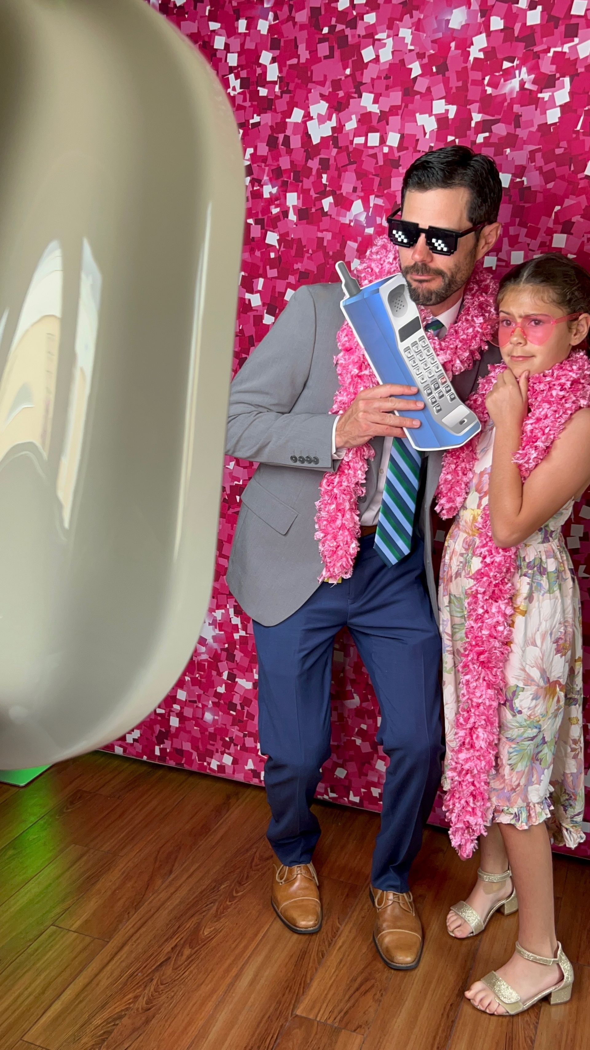 Guest wearing sunglasses at Fiesta 360 pink photo booth backdrop Tampa event