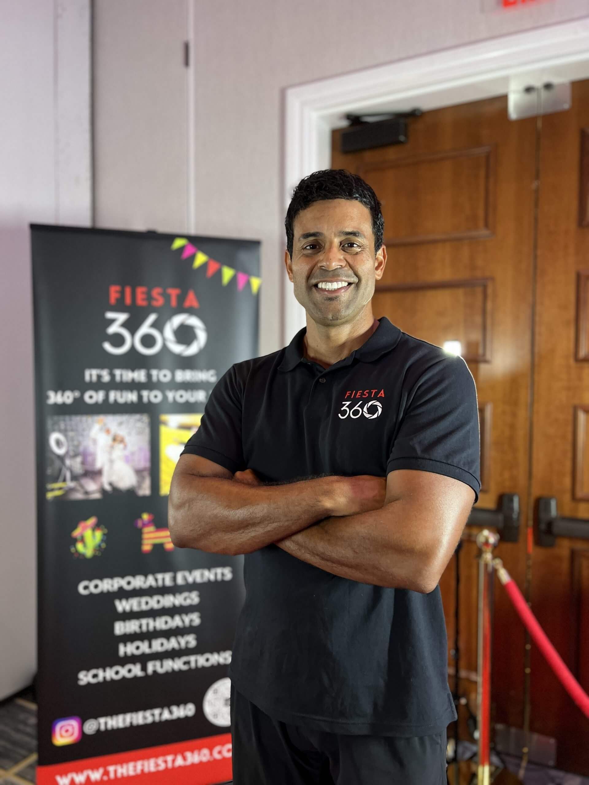 A man standing in front of a sign that says fiesta 360