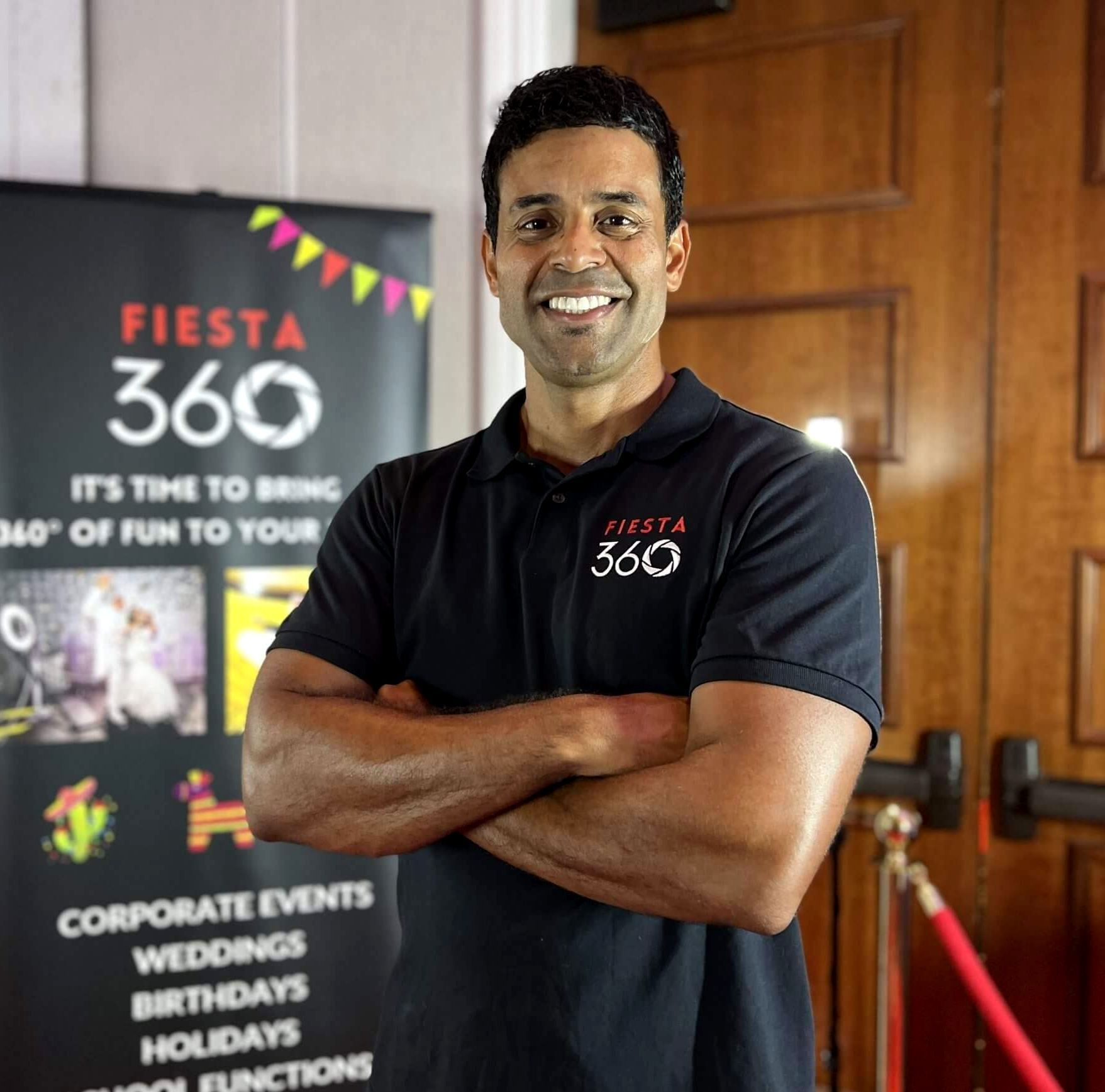 A man standing in front of a sign that says fiesta 360