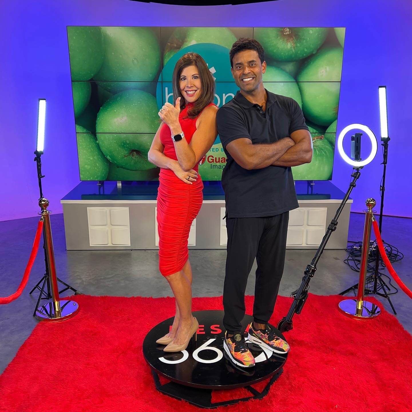 A man and a woman are standing next to each other in a studio.