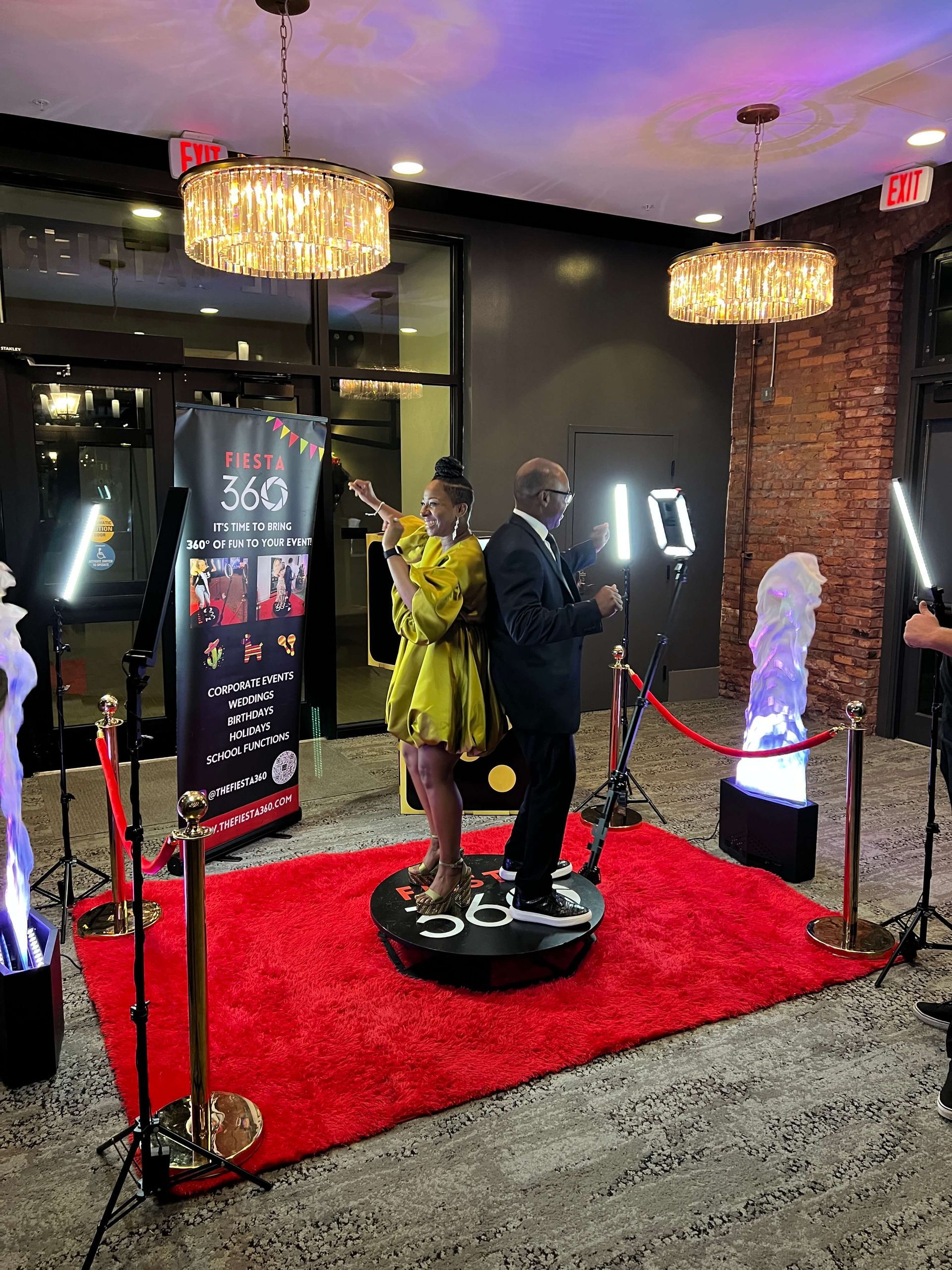 A man and a woman are posing for a picture on a red carpet.