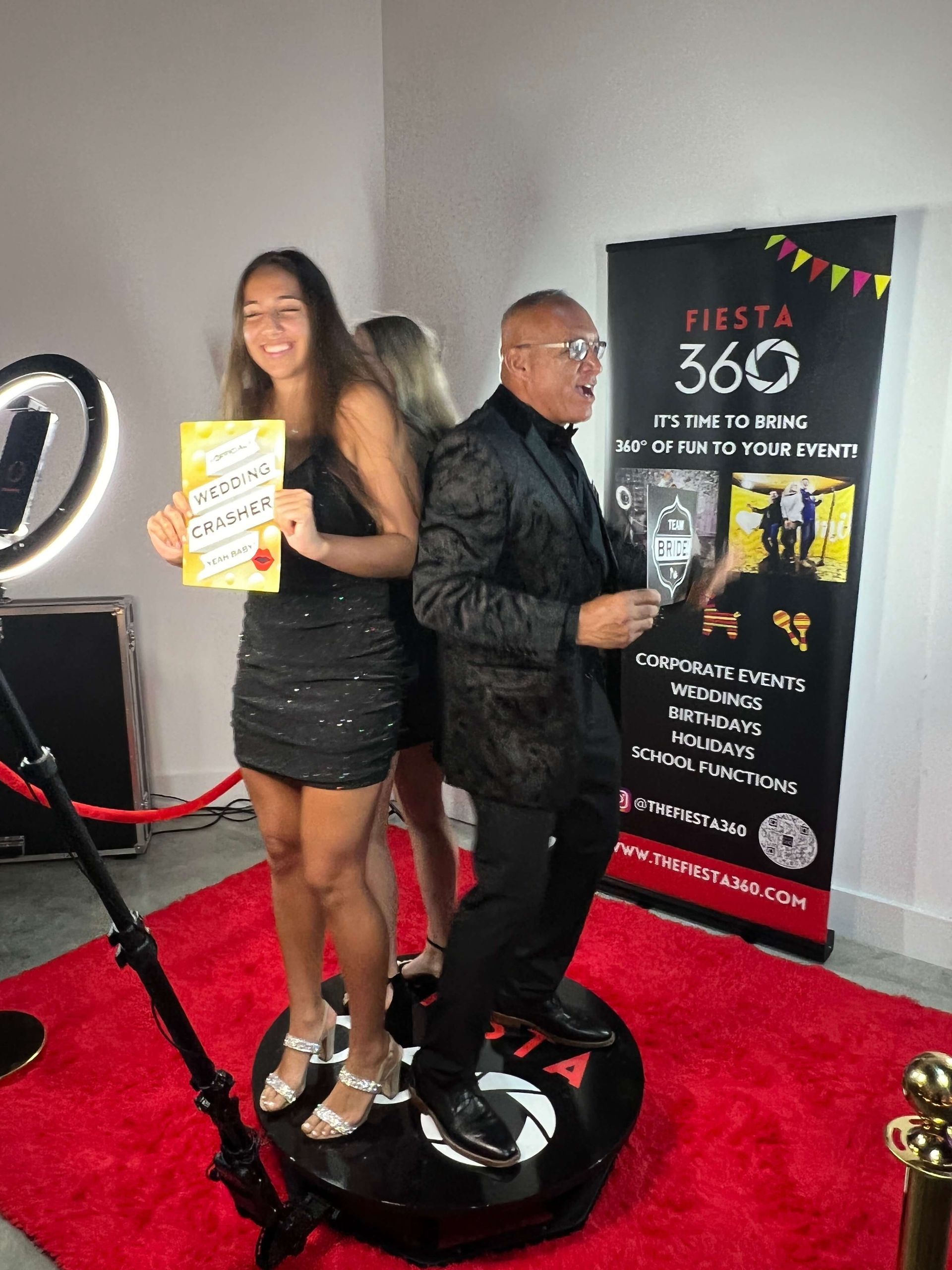A man and a woman are standing next to each other on a red carpet.