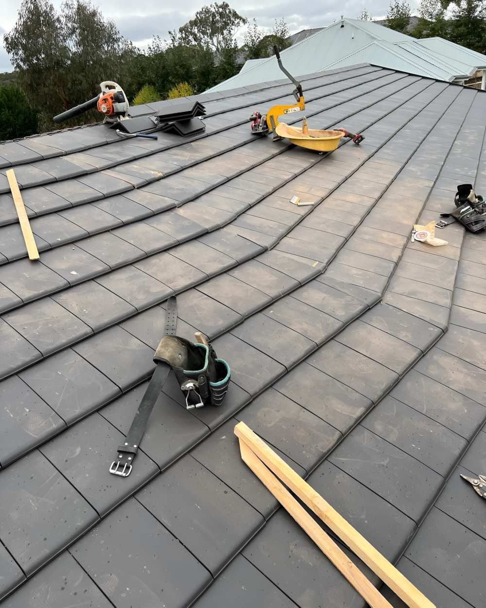 A Roof With A Lot Of Tiles And Tools On It During Installation — Lance Ward Roof Tiling in Orange, NSW