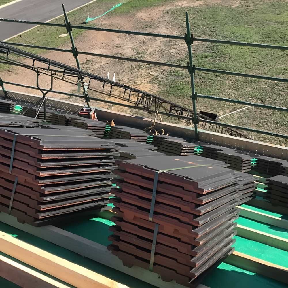 A Stack Of Roof Tiles Sitting On Top Of A Green Roof — Lance Ward Roof Tiling in Orange, NSW