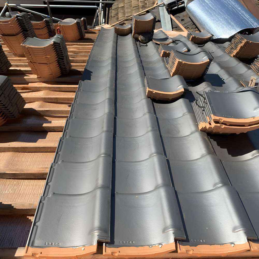 A Roof With A Lot Of Tiles On It Is Being Built — Lance Ward Roof Tiling in Orange, NSW