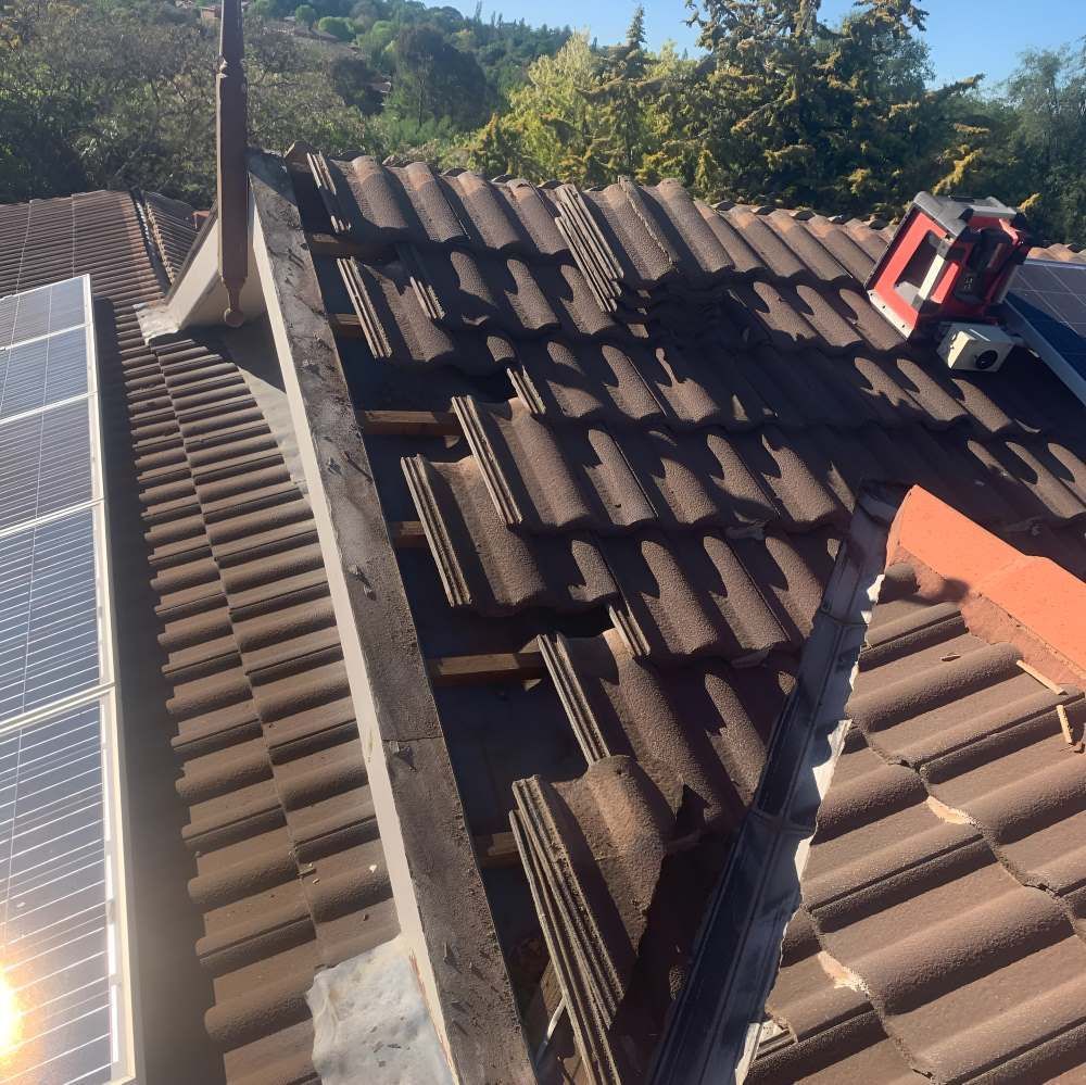 A Roof With A Few Solar Panels And Tools — Lance Ward Roof Tiling in Orange, NSW
