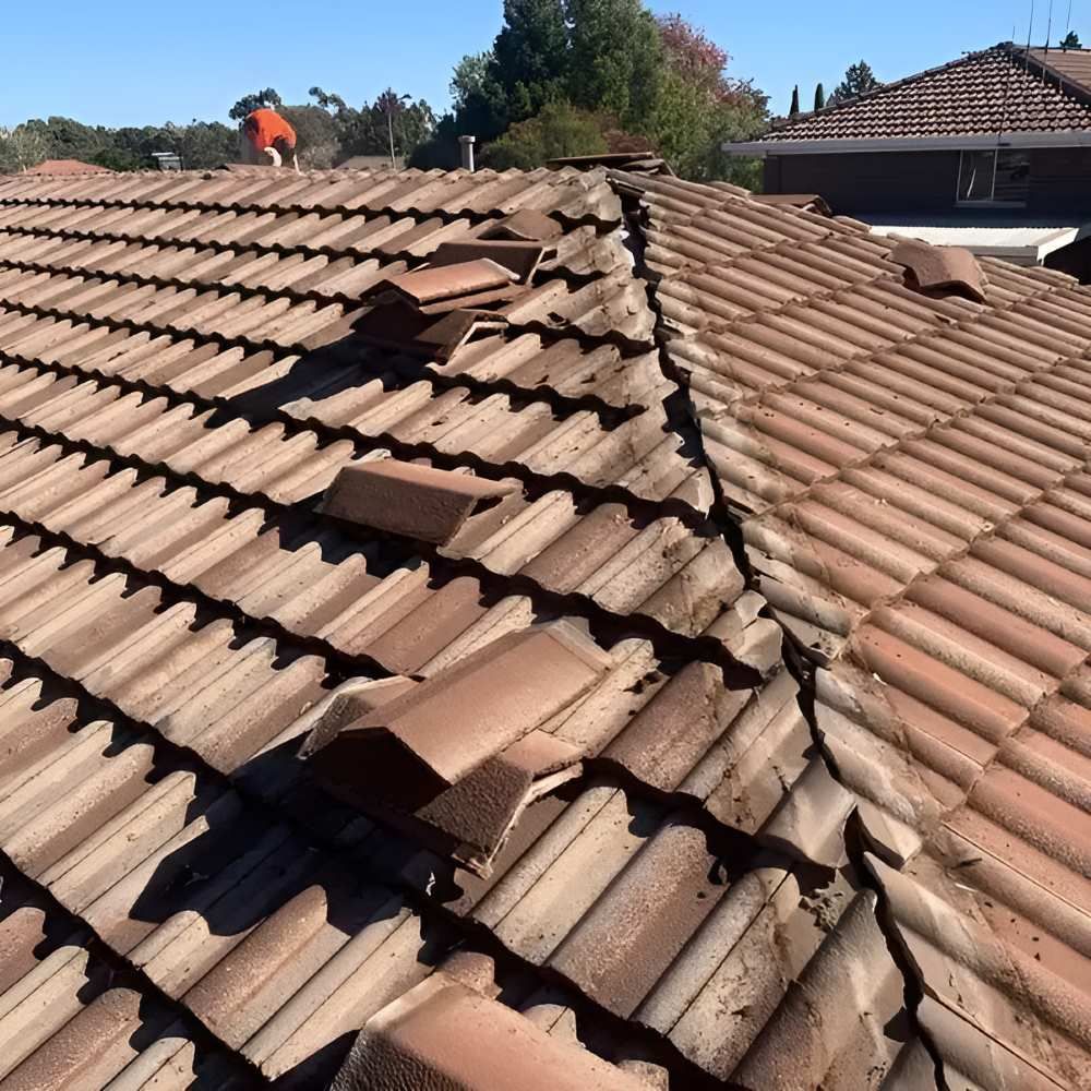 A Man Replacing The Old Tiled Roof — Lance Ward Roof Tiling in Cowra, NSW