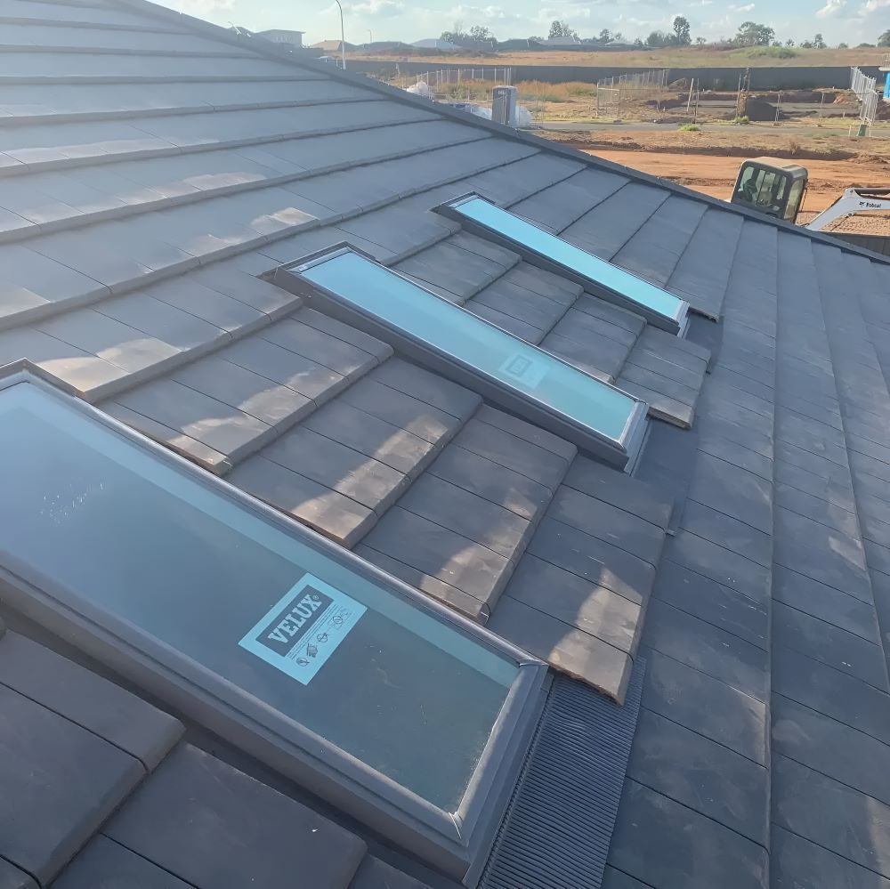 A Roof With A Skylight That Says Velux On It — Lance Ward Roof Tiling in Lithgow, NSW