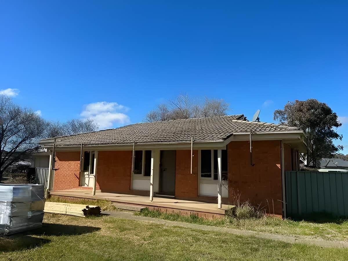 A Brick House With A Tiles Roof — Lance Ward Roof Tiling in Lithgow, NSW