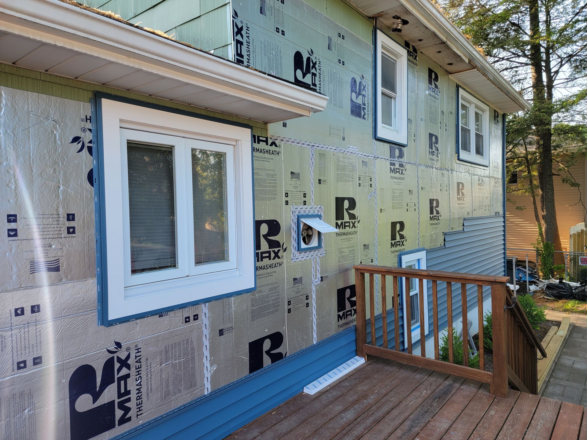 A house with a deck and a window on the side of it.