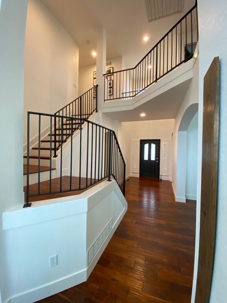 A hallway with stairs leading up to the second floor