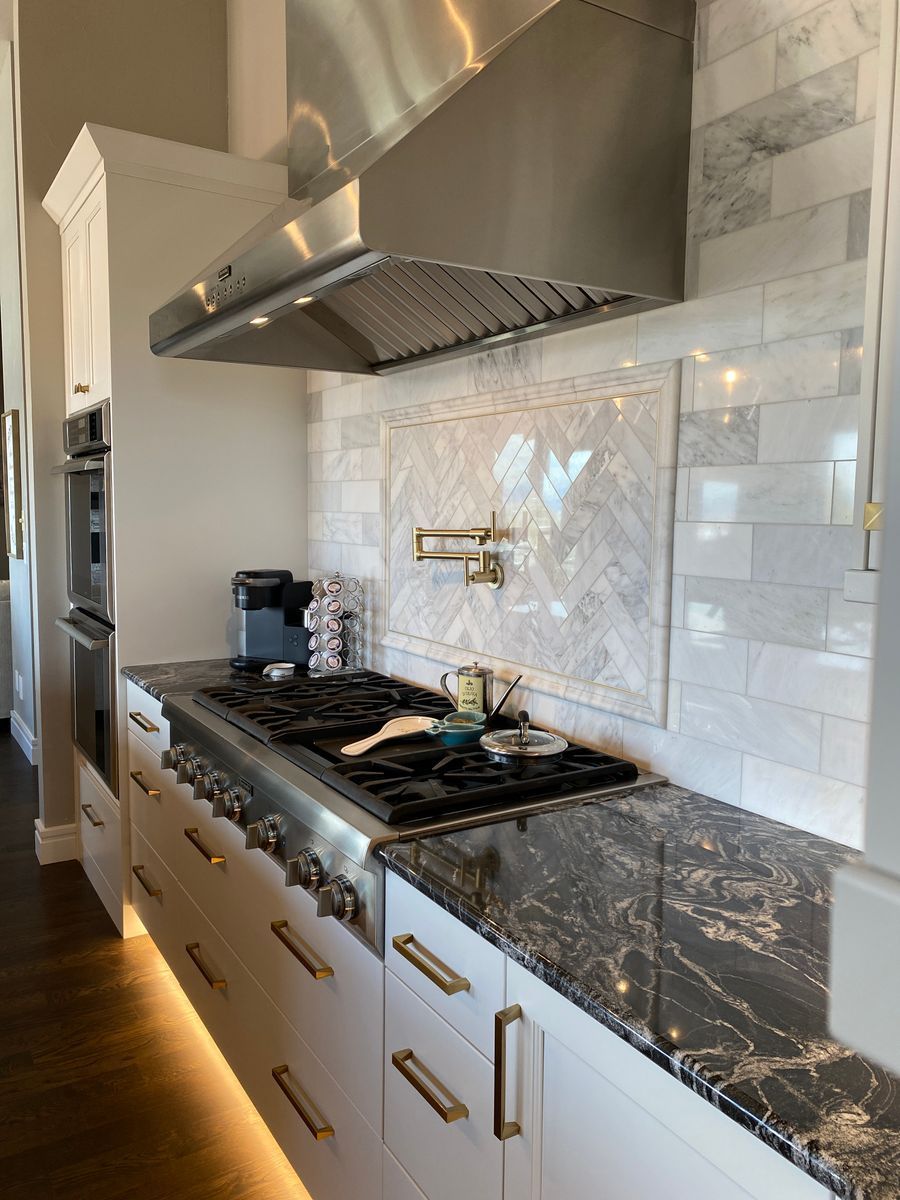 A kitchen with stainless steel appliances and granite counter tops