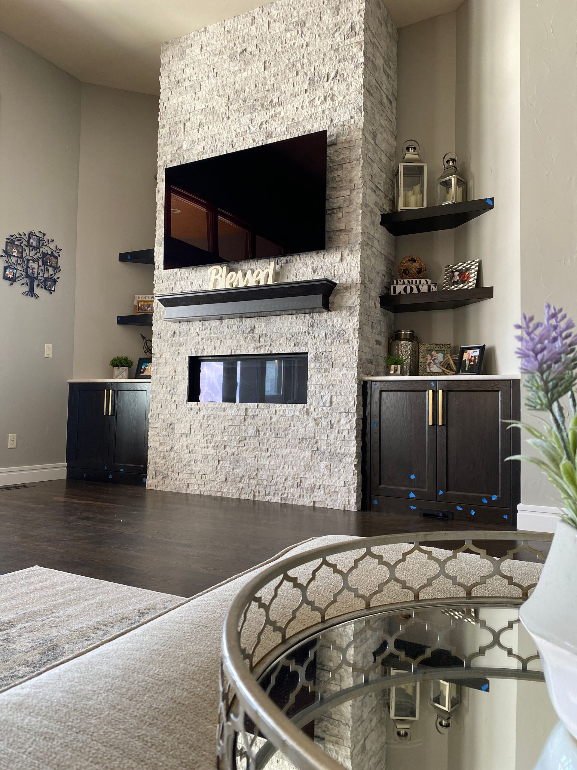 A living room with a fireplace and a flat screen tv