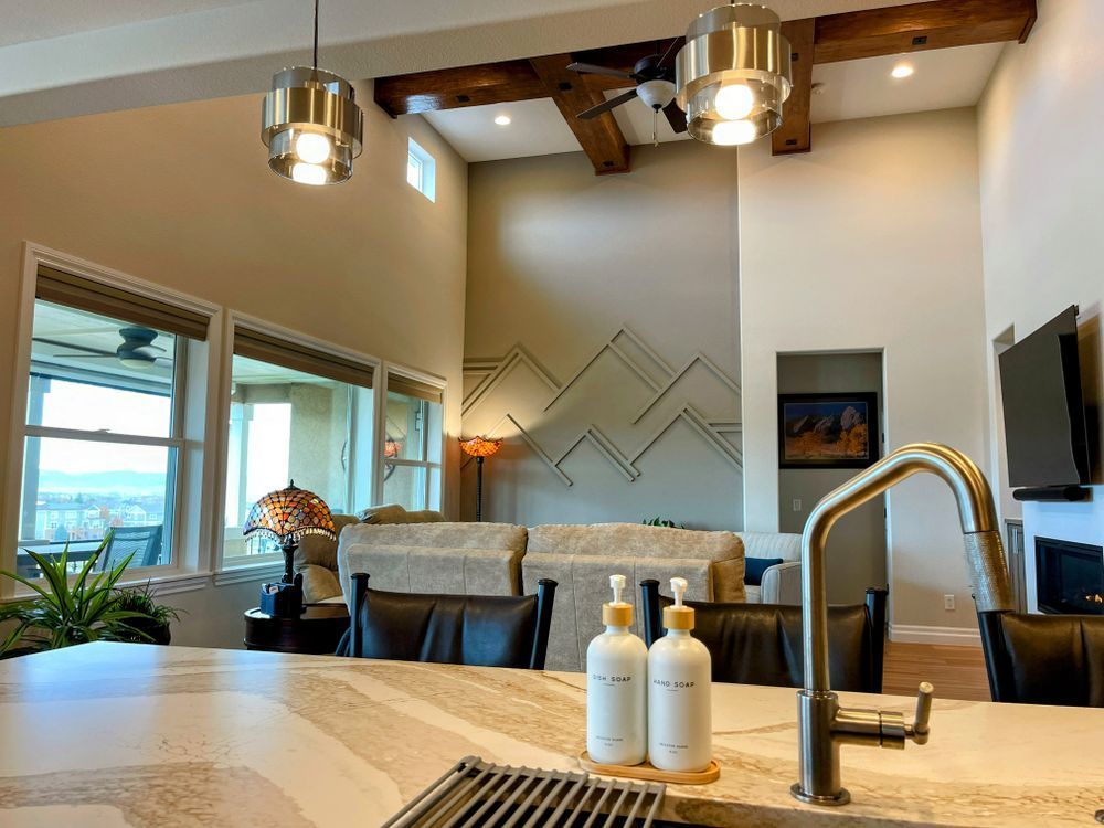 A kitchen with a sink and two bottles of soap on the counter.