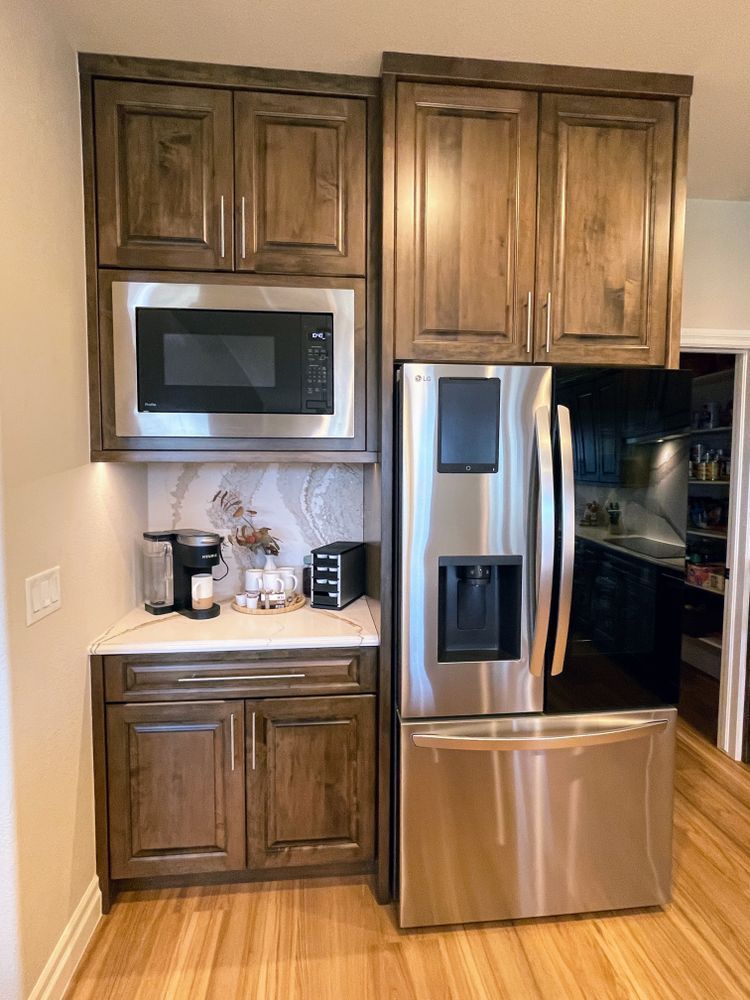 A kitchen with stainless steel appliances and wooden cabinets.