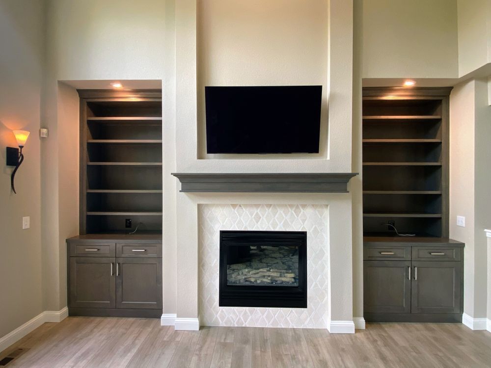 A living room with a fireplace and a flat screen tv