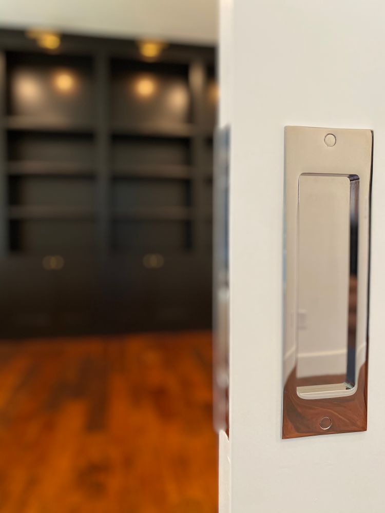A door with a handle on it and a bookshelf in the background