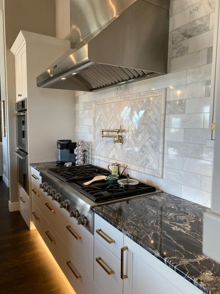 A kitchen with stainless steel appliances and granite counter tops