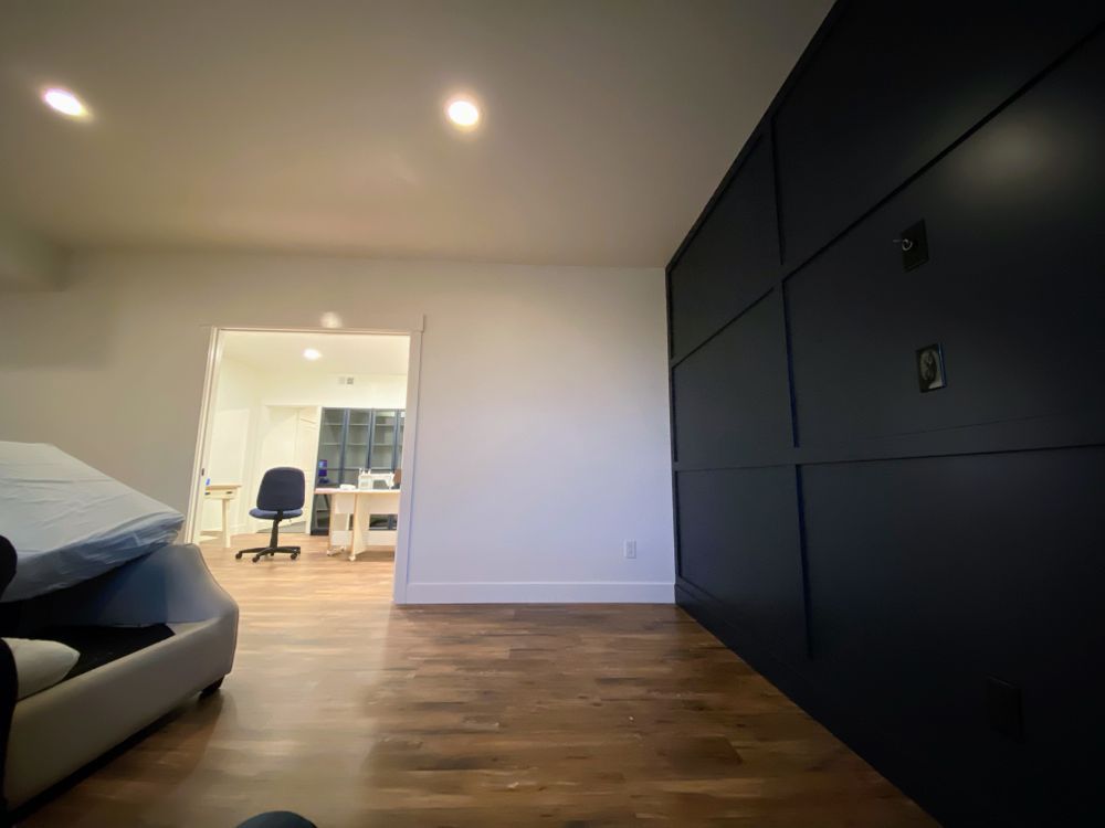 A room with a couch and a desk in it.