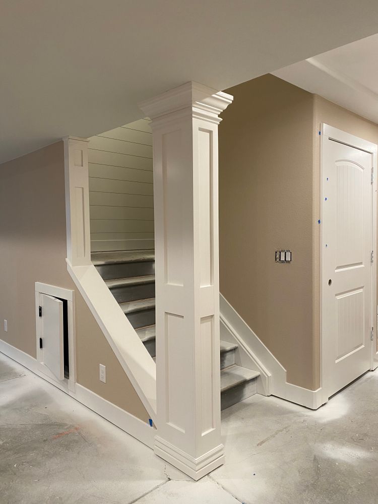 A basement with stairs leading up to the second floor