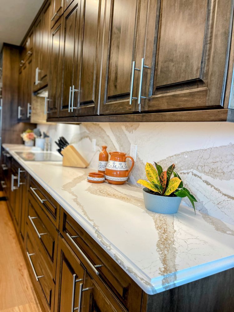A kitchen with wooden cabinets and a white counter top.