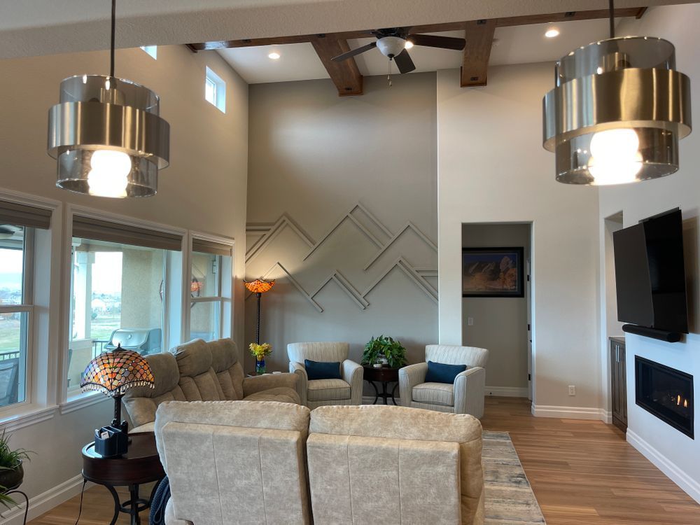 A living room with a couch and chairs and a fireplace