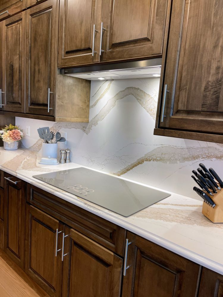 A kitchen with wooden cabinets and a stove top oven.