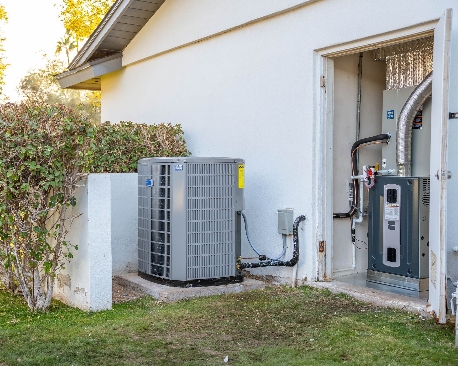 Residential split HVAC system with outdoor AC condenser and indoor furnace installation at a Phoenix home.