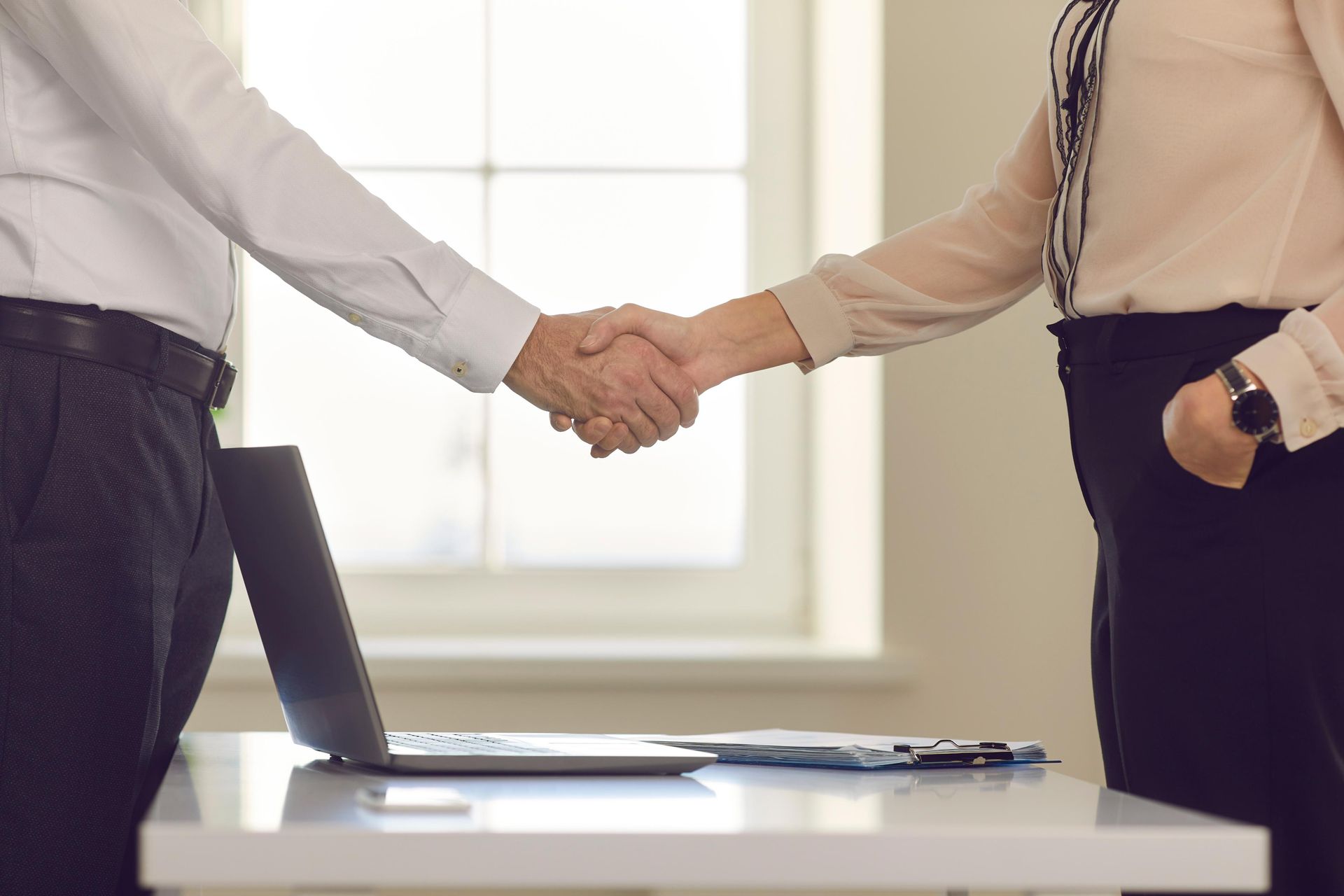 A man and a woman are shaking hands.