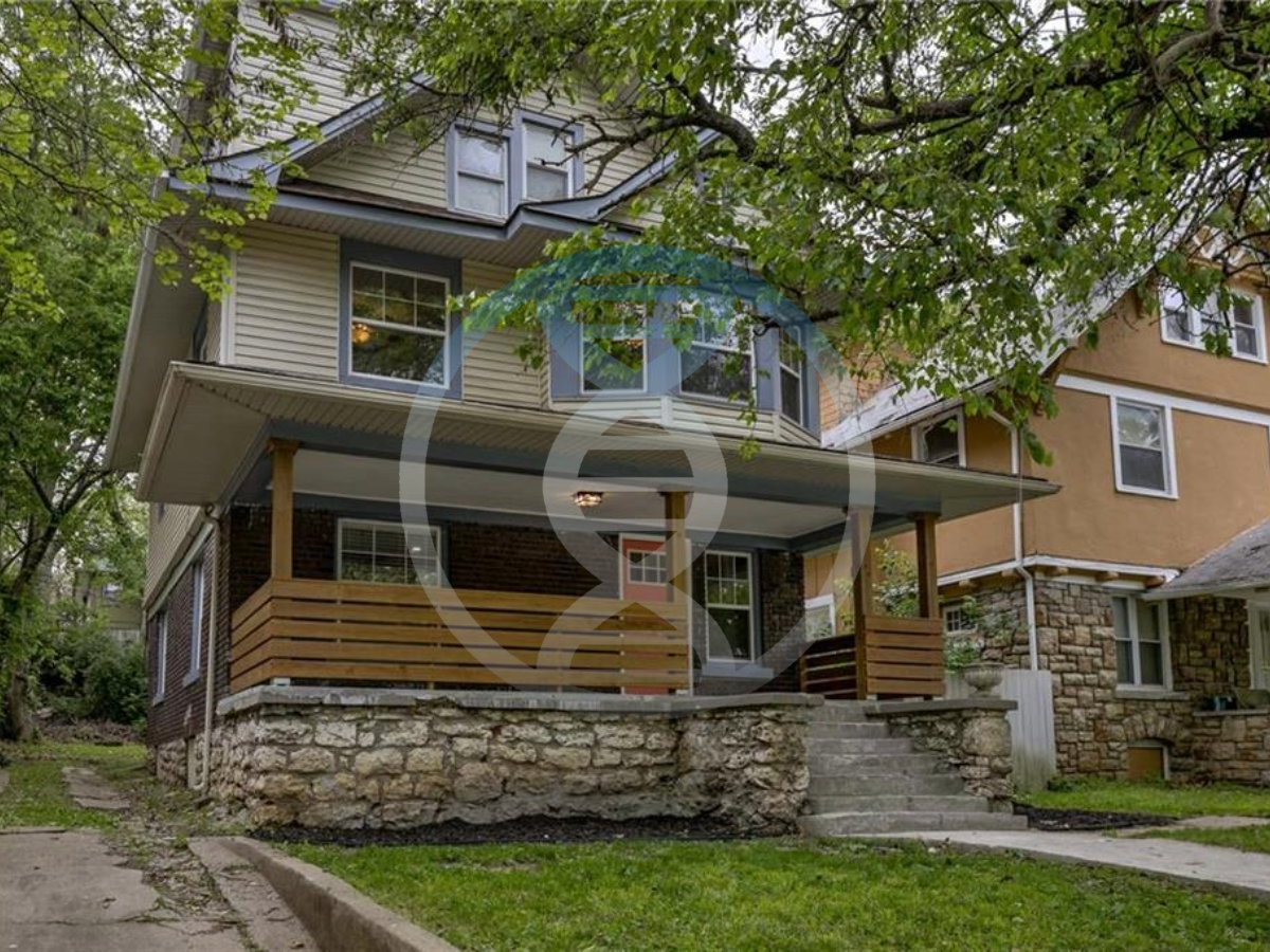 a house with a porch and stairs in front of it .