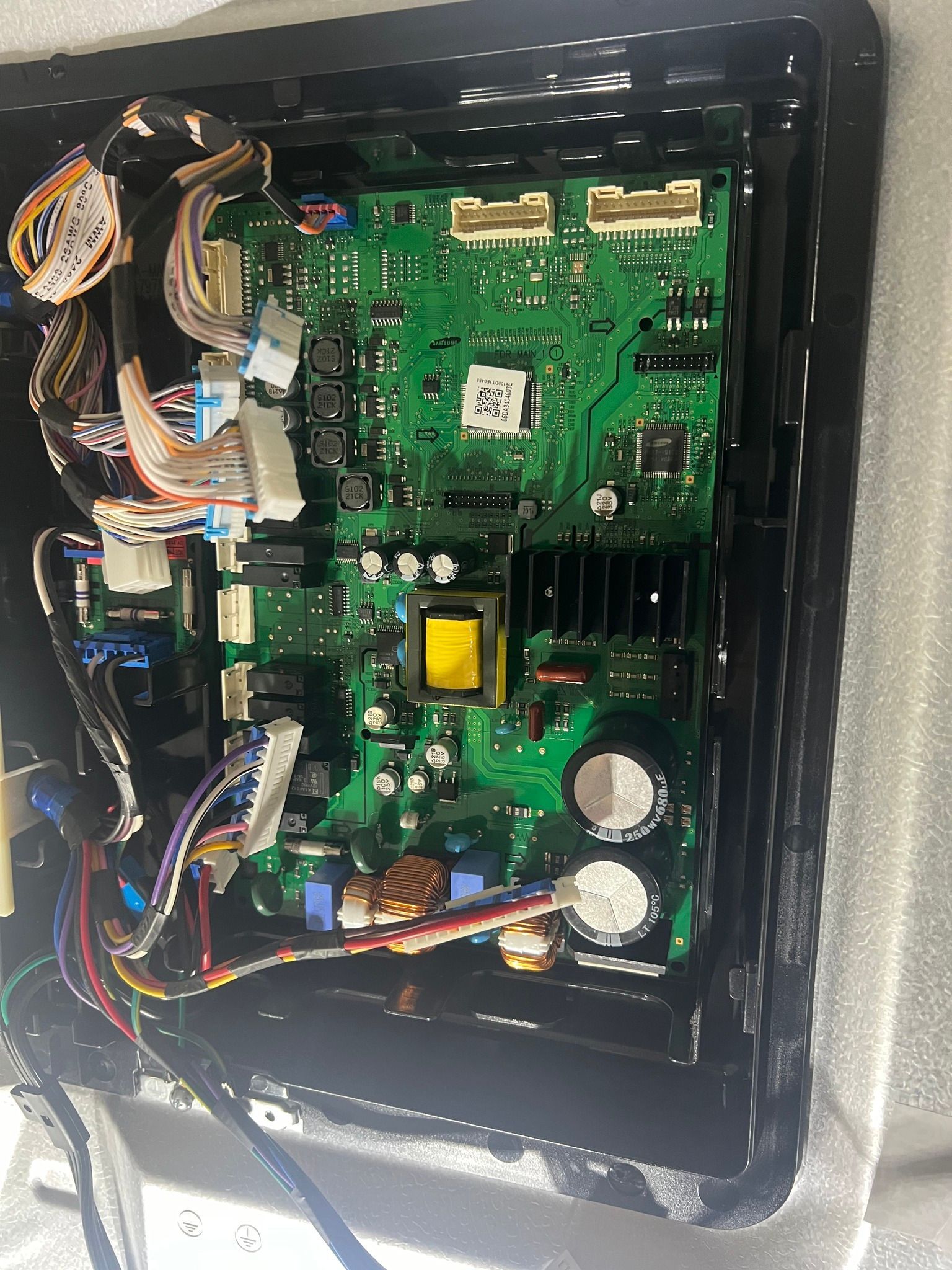 A close up of a motherboard with a lot of wires coming out of it.