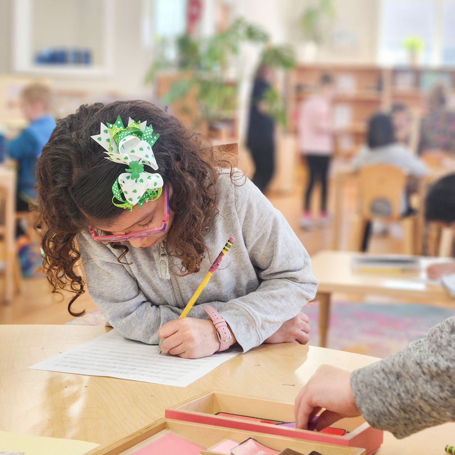 A Montessori child working in the classroom.