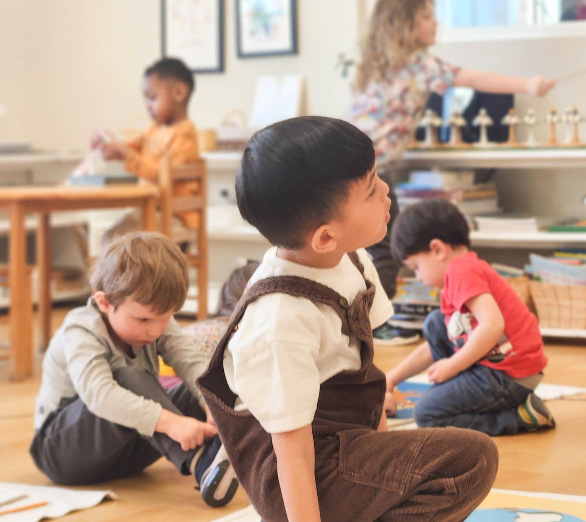 A group of montessori children are working in the classroom