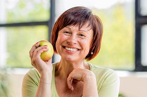 Older woman holding apple