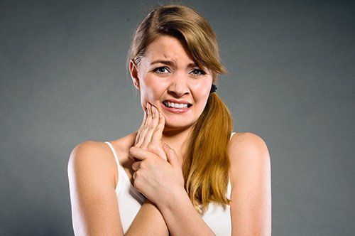 Young lady having tooth pain