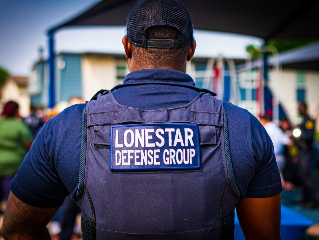 A man is wearing a lonestar defense group vest.