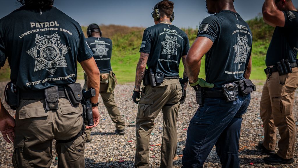 A group of police officers are standing next to each other in a field.