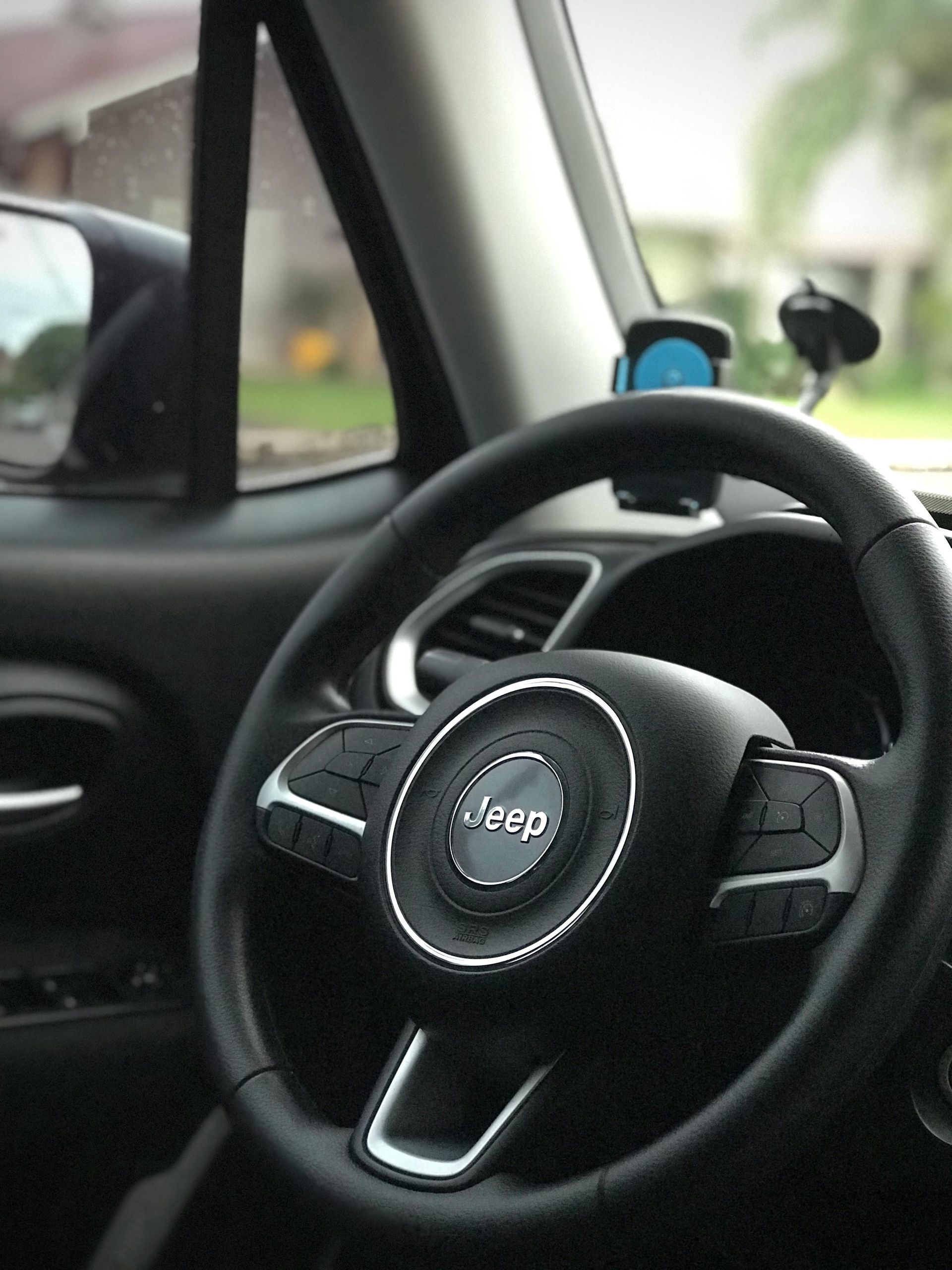 A close up of a steering wheel in a jeep