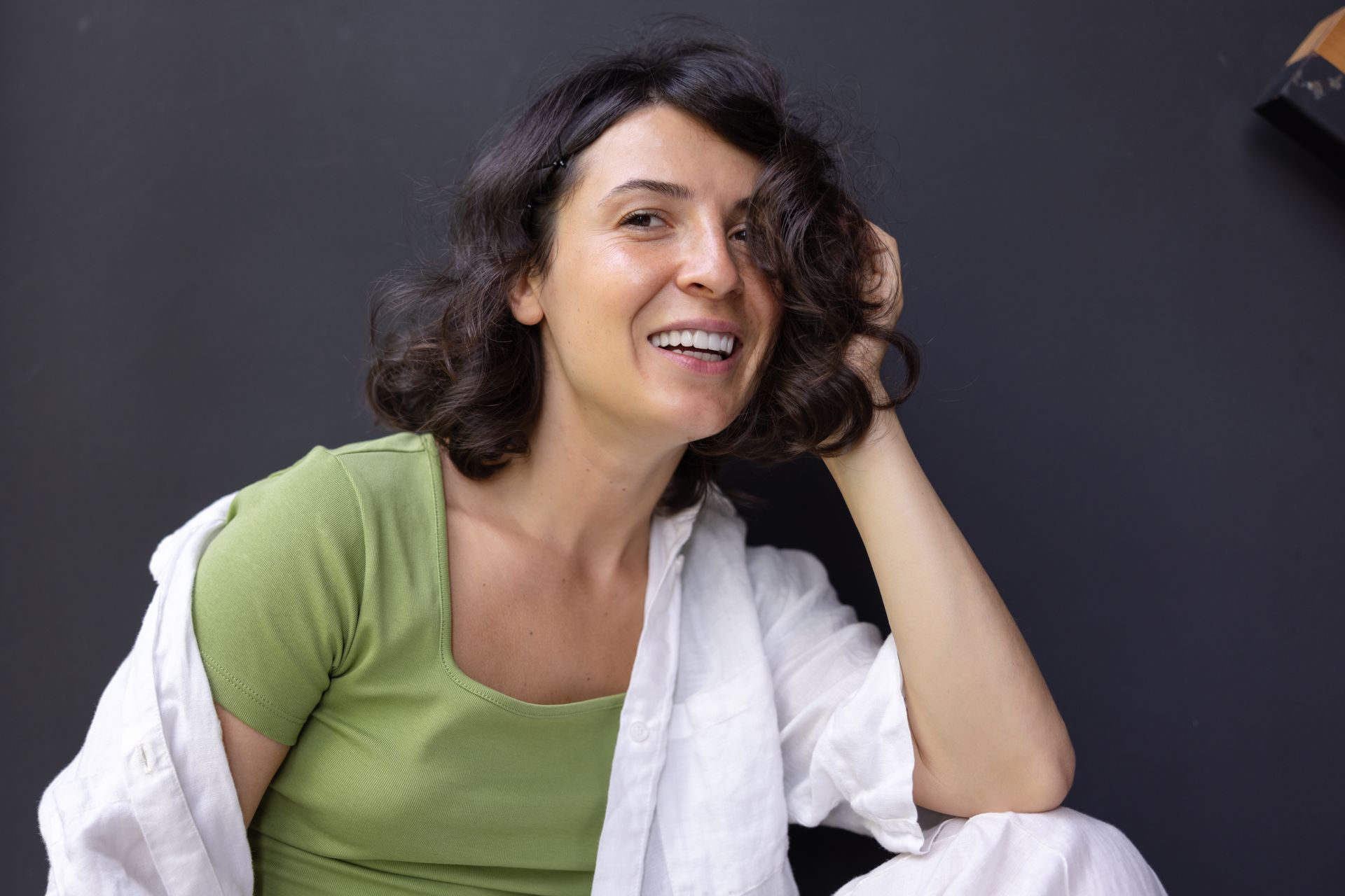 A woman enjoying thicker, healthier hair after using HRT for hair regrowth
