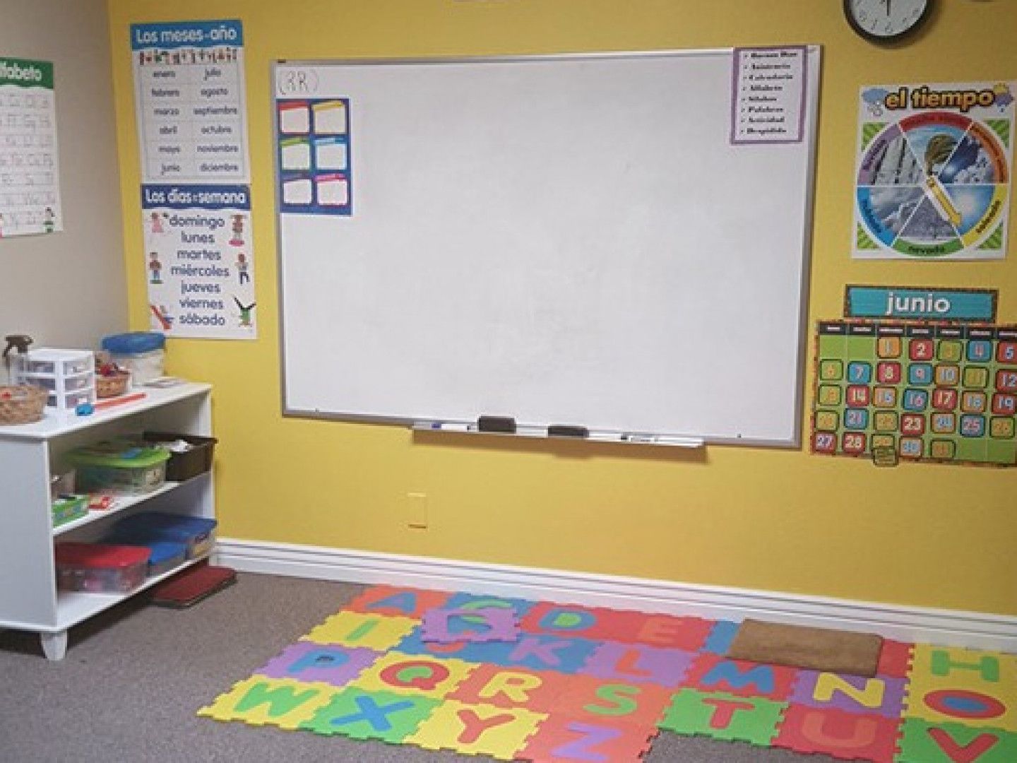 A Classroom With Yellow Walls and a White Board