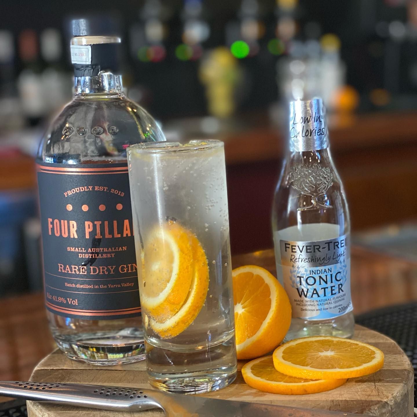 A Bottle of Four Pilla Vodka Next to A Glass of Vodka — Roundabout Inn in Gloucester, NSW