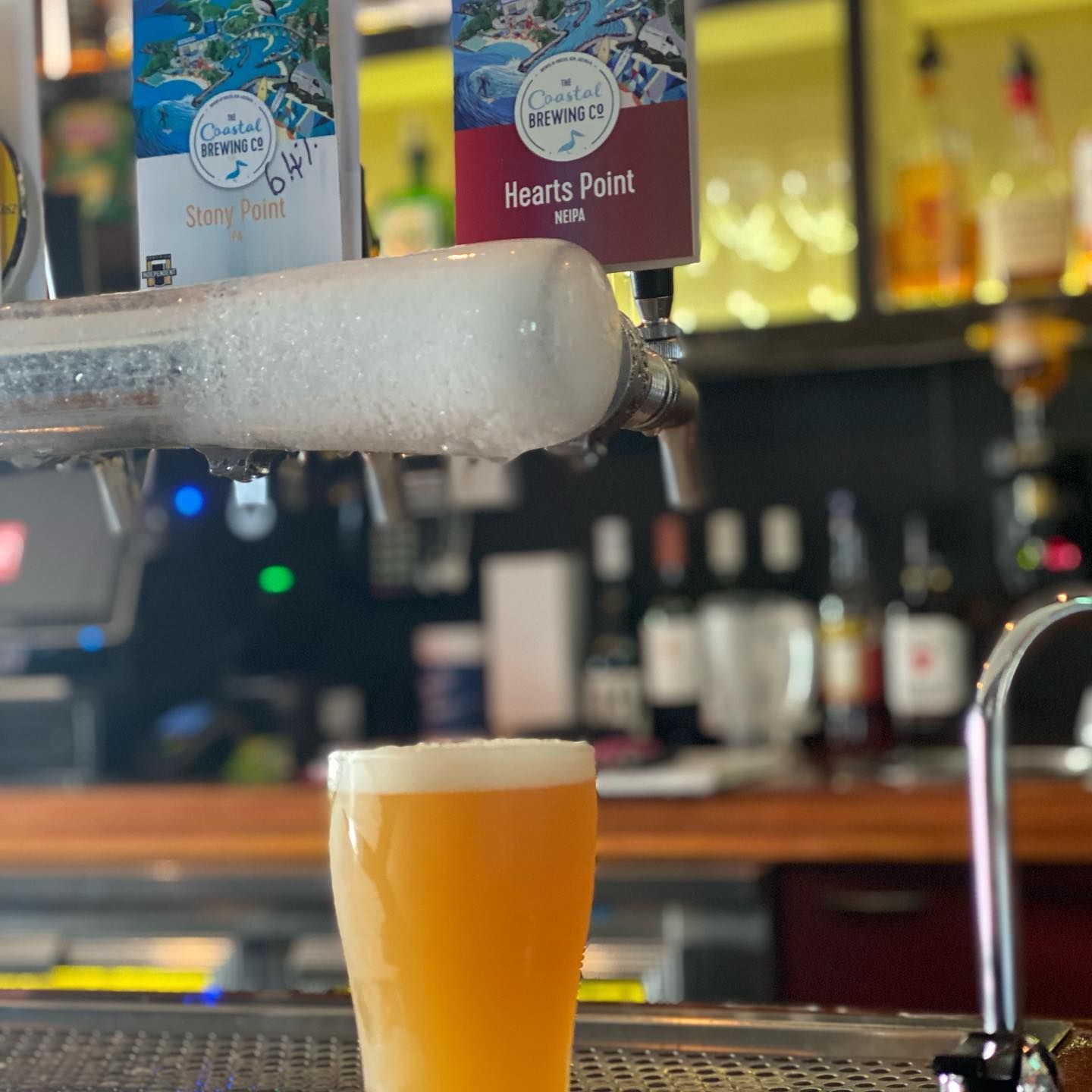 A Glass of Beer Is Being Poured from A Tap in A Bar — Roundabout Inn in Gloucester, NSW