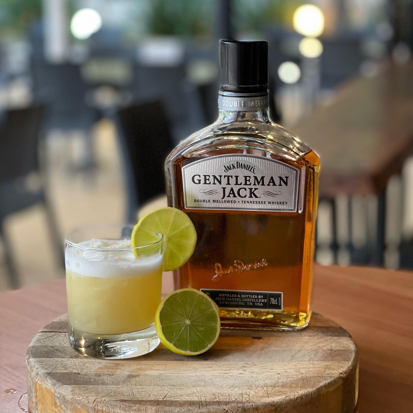 Jack Whiskey Is on A Wooden Cutting Board Next to A Glass of Whiskey — Roundabout Inn in Gloucester, NSW