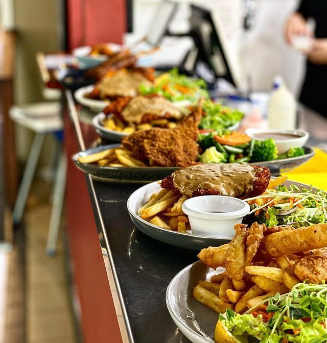 A Row of Plates of Food Are Lined up On a Counter — Roundabout Inn in Gloucester, NSW