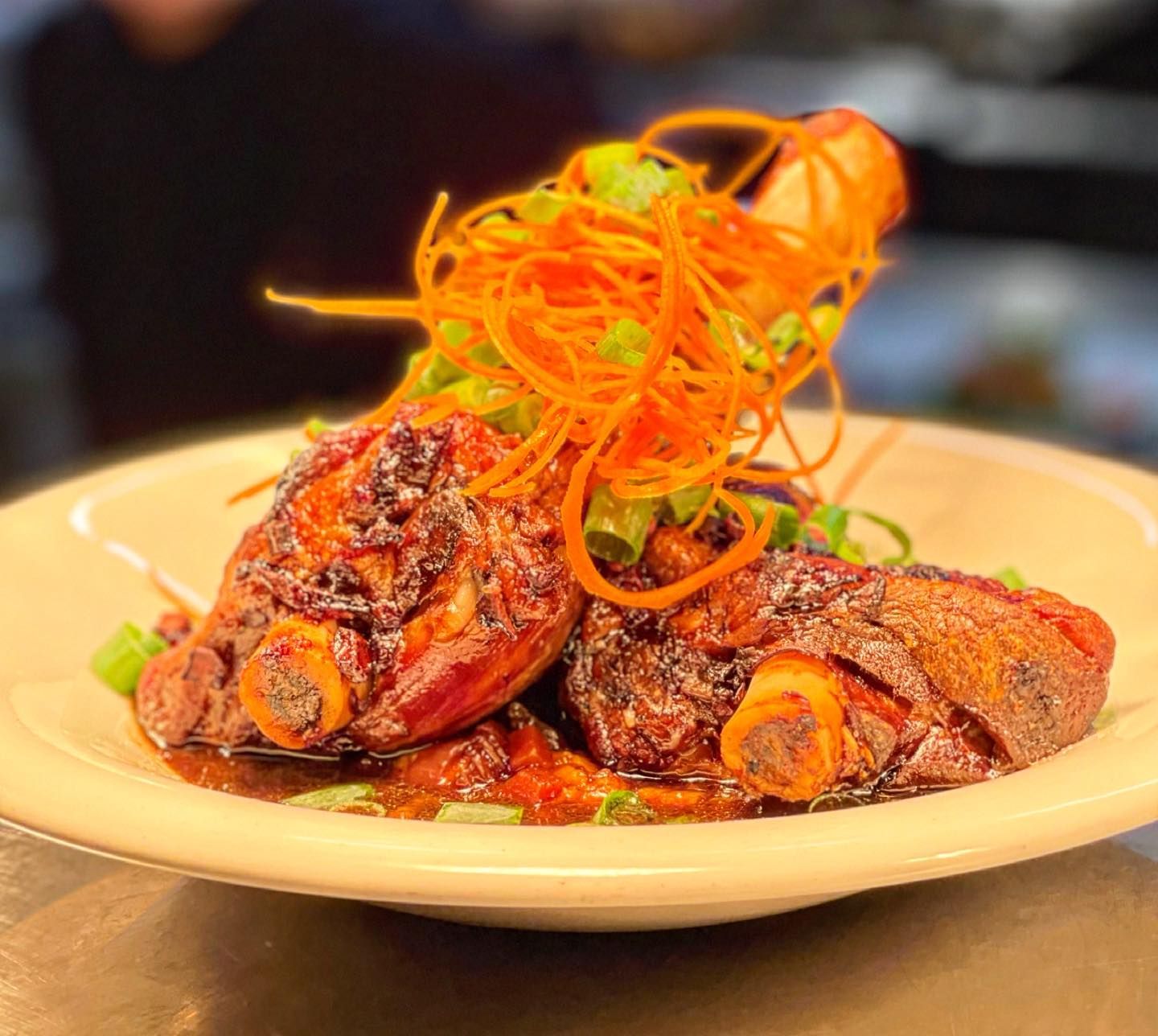 A White Plate Topped with Meat and Carrots on A Table — Roundabout Inn in Gloucester, NSW
